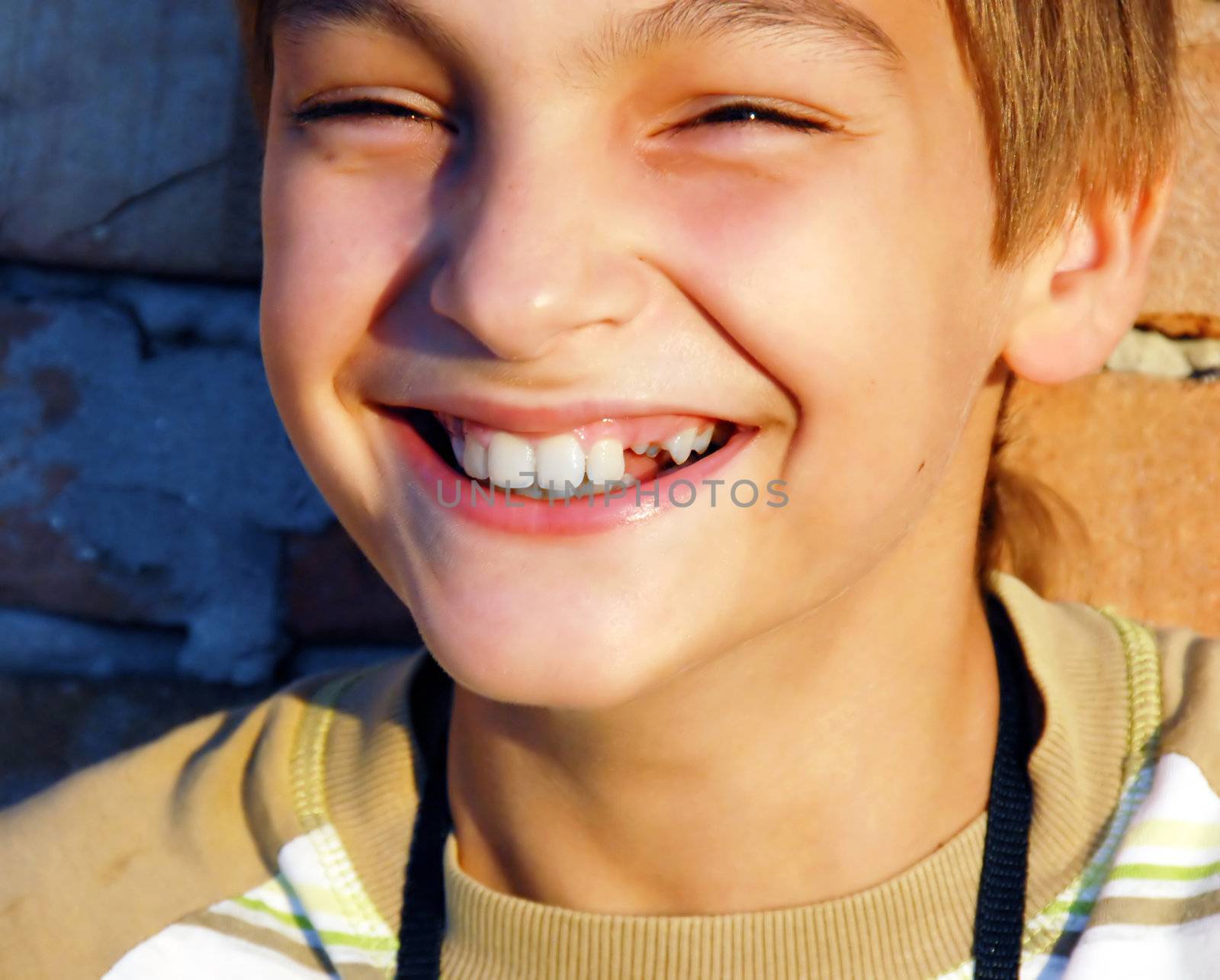 laughing teen caucasian boy with missing tooth portrait