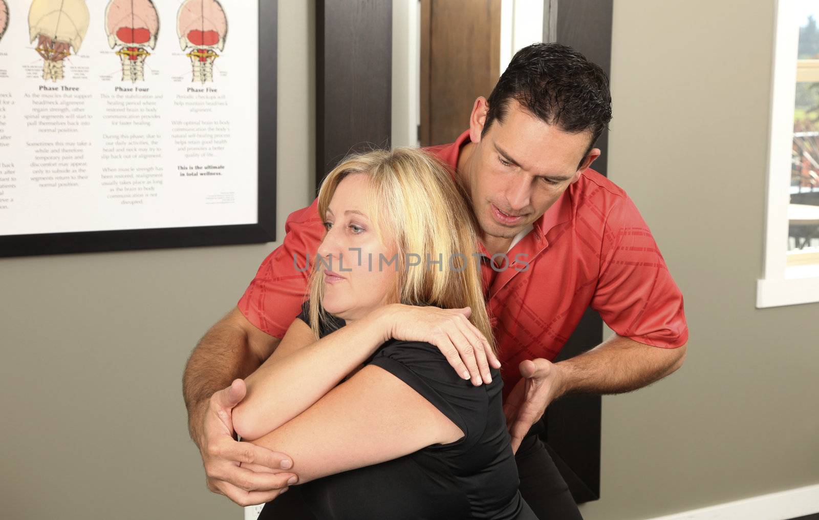 Chiropractor adjusting a female patient