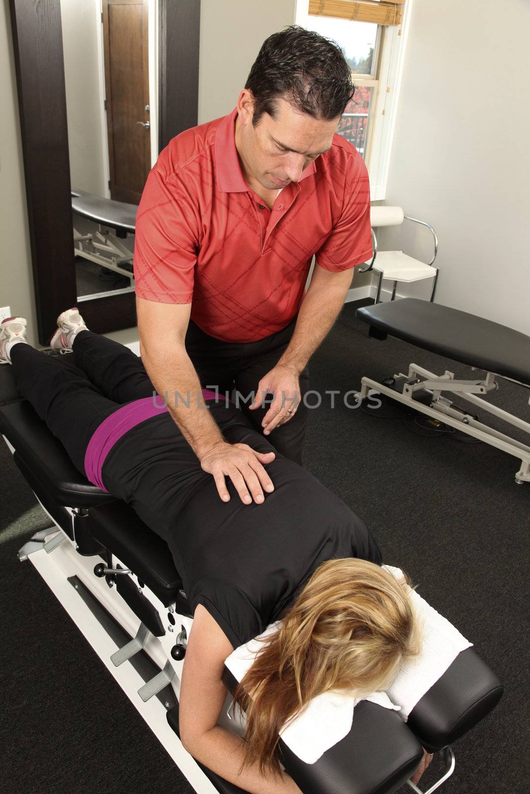 Chiropractor adjusting a female patient