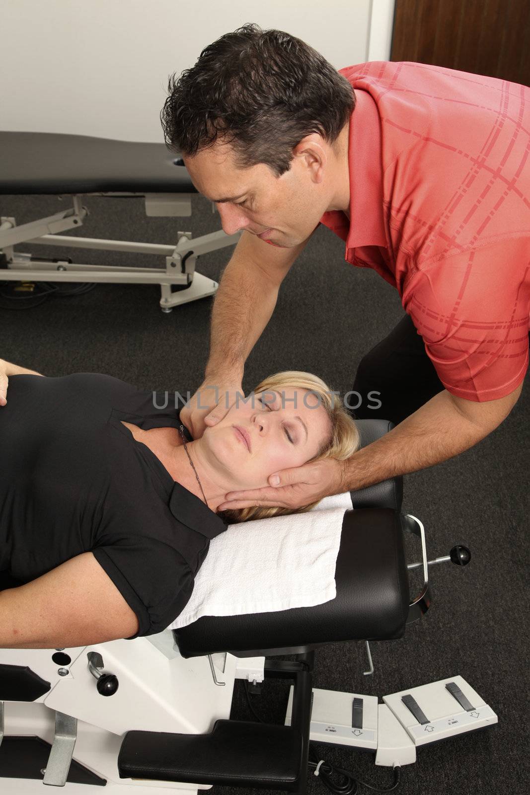 Chiropractor adjusting a female patient