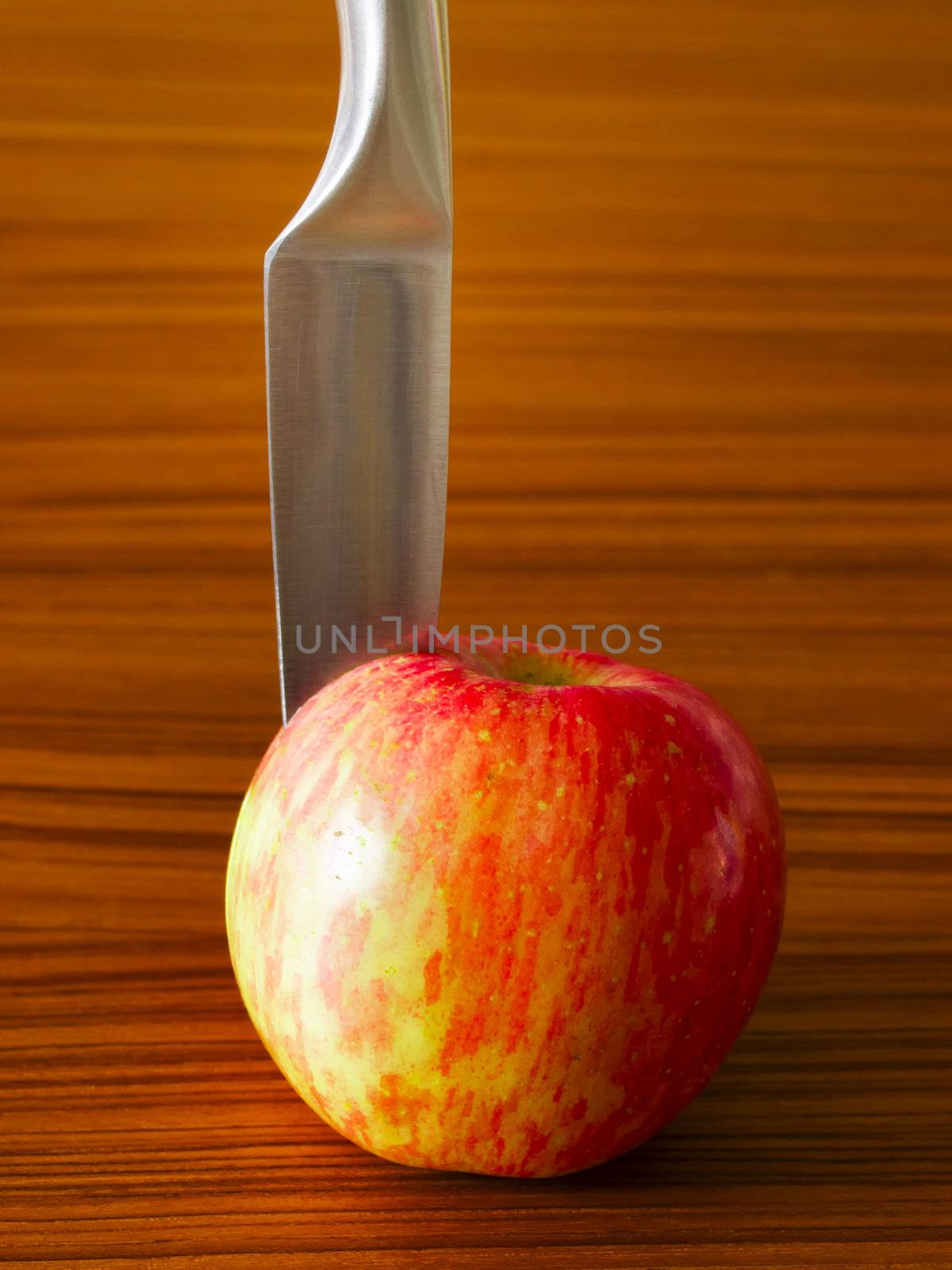 close up of red apple with knife