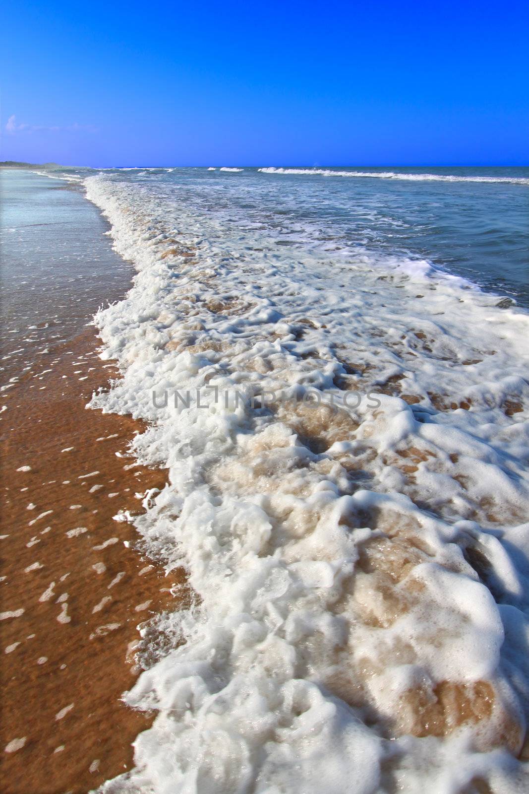 Waves crash along the coast on a beautiful day in Daytona Beach, Florida.