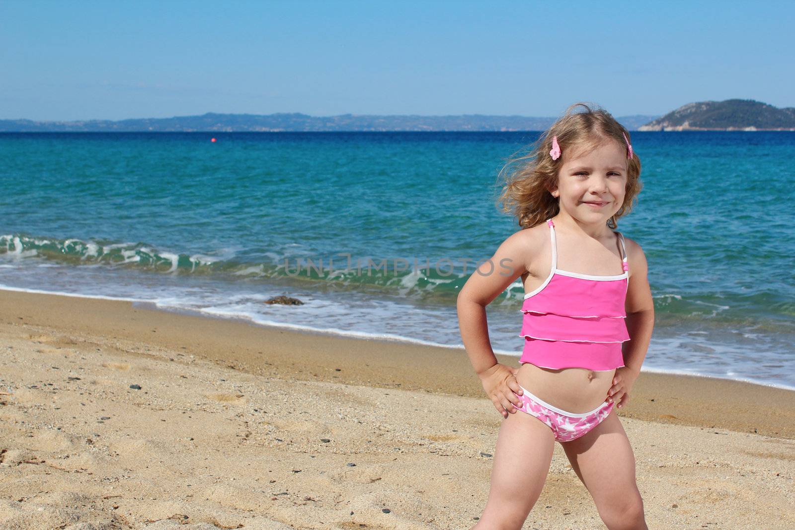 beauty little girl posing on the beach by goce