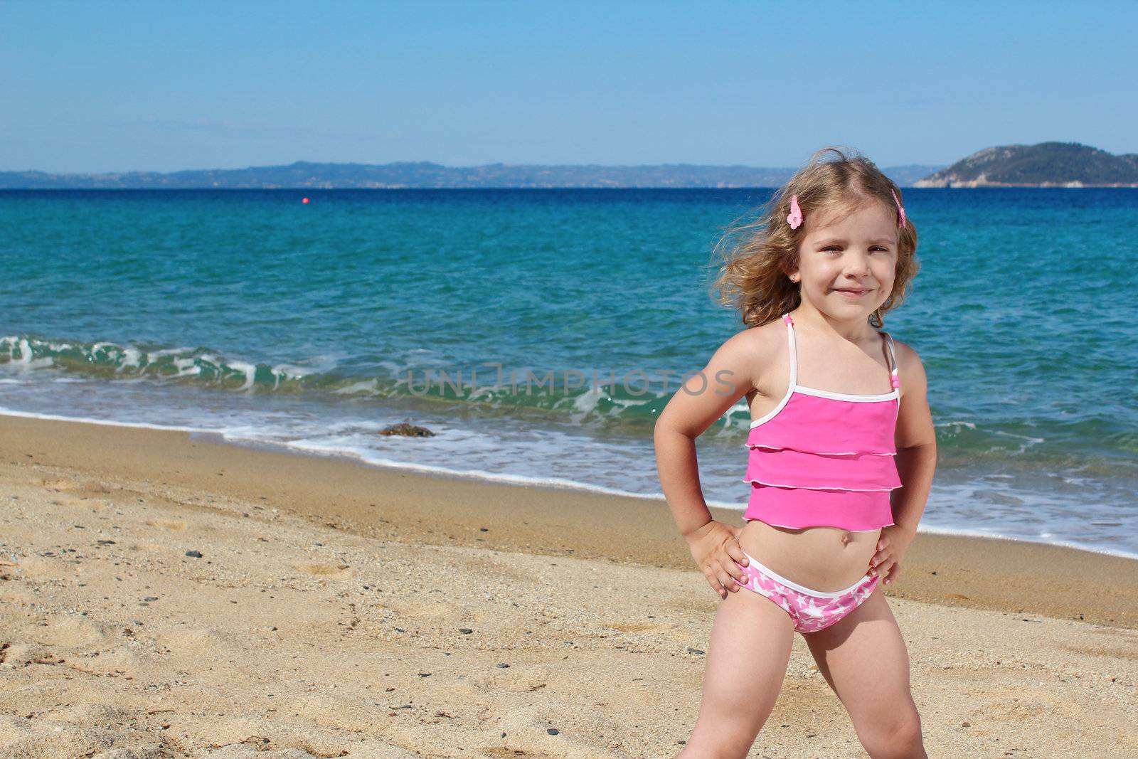 beauty little girl posing on the beach