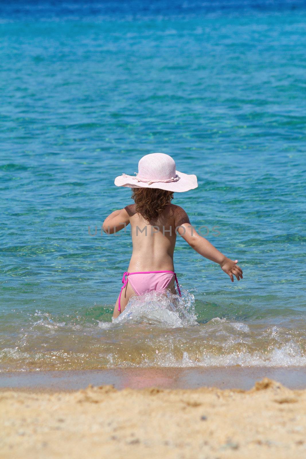 little girl running in sea