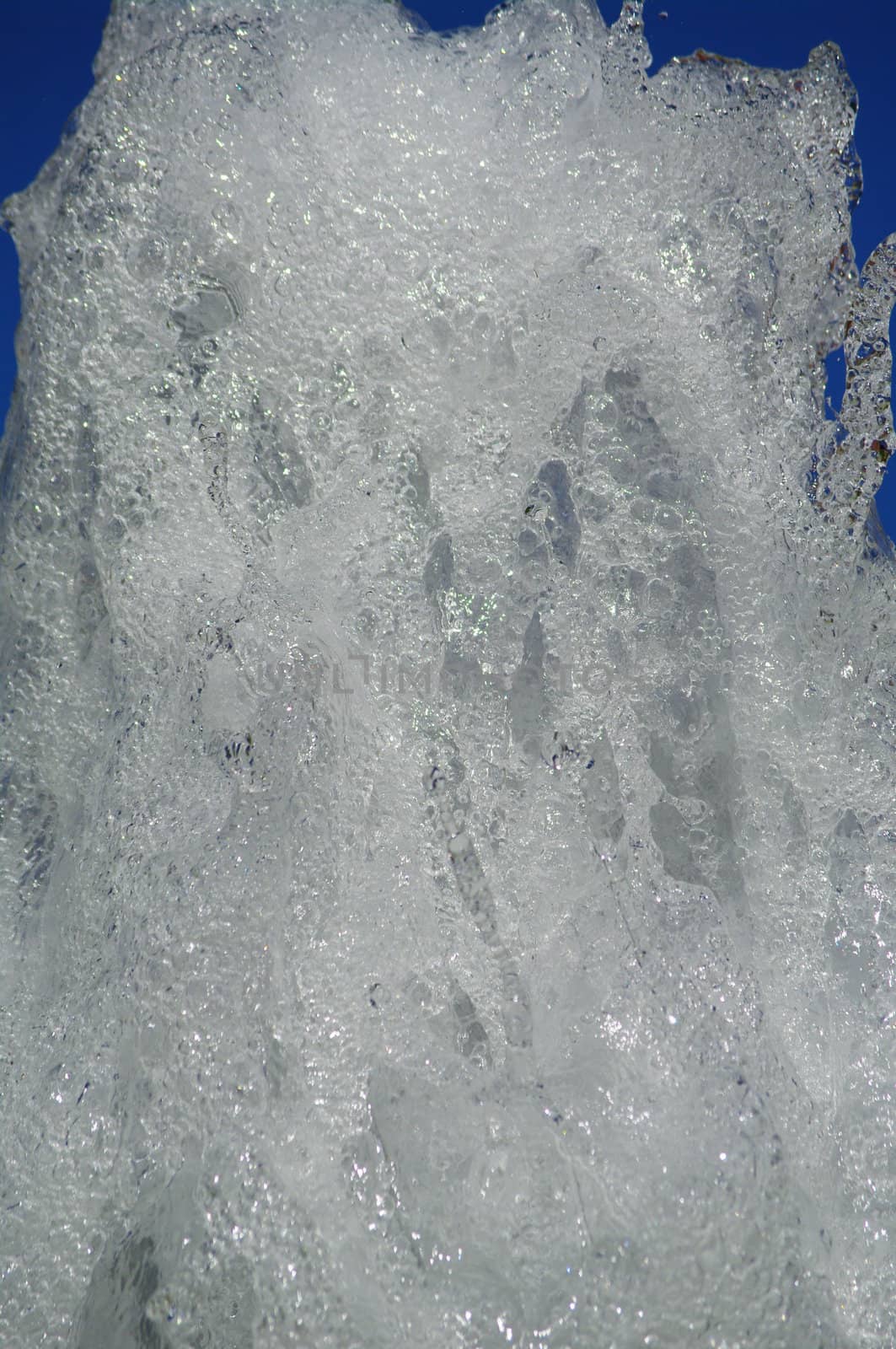 fresh water from a fountain against blue sky