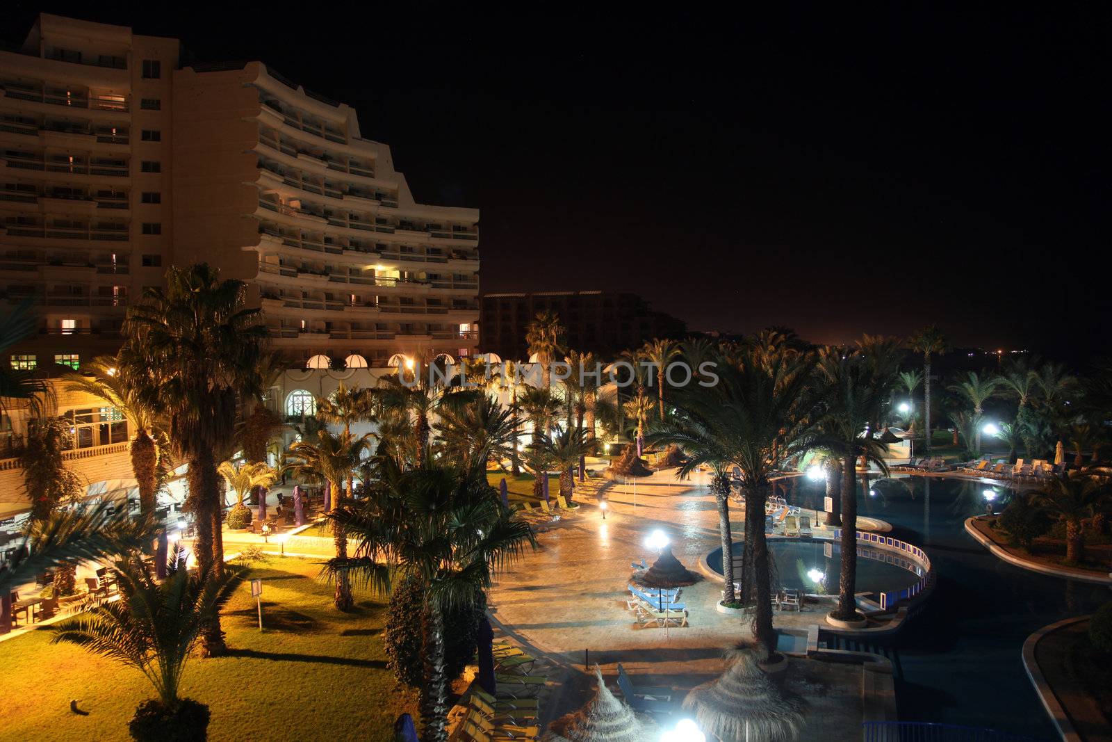 Hotel pool at night by atlas