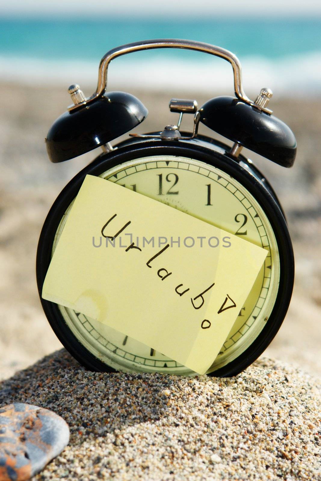 a closeup of an old clock on a beach