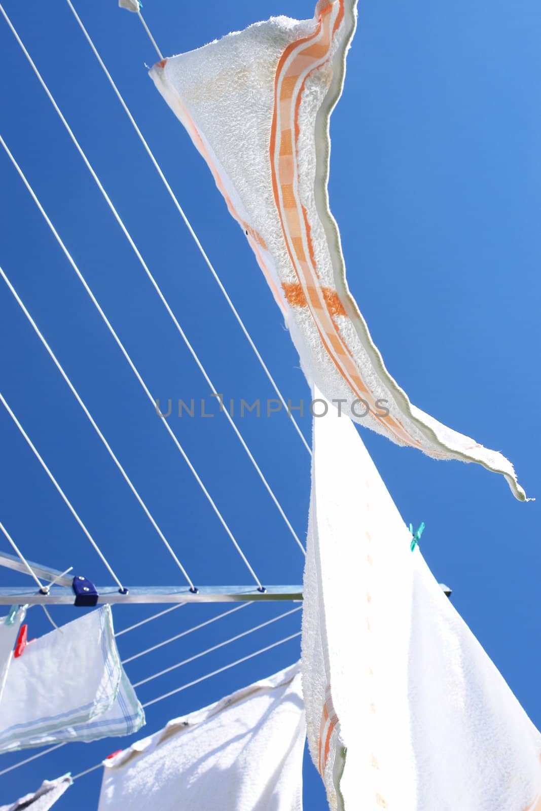 fresh washed laundry on rotary clothes dryer