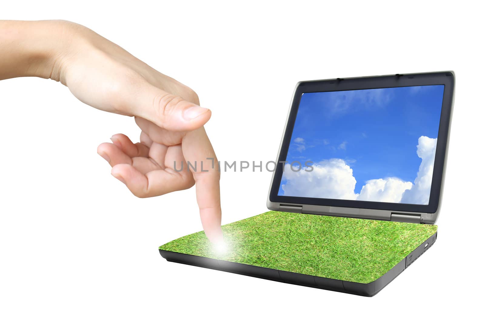 hands are working on laptop in grass