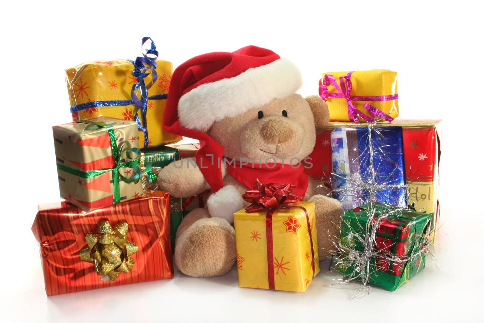 Christmas presents and teddy in front of white background