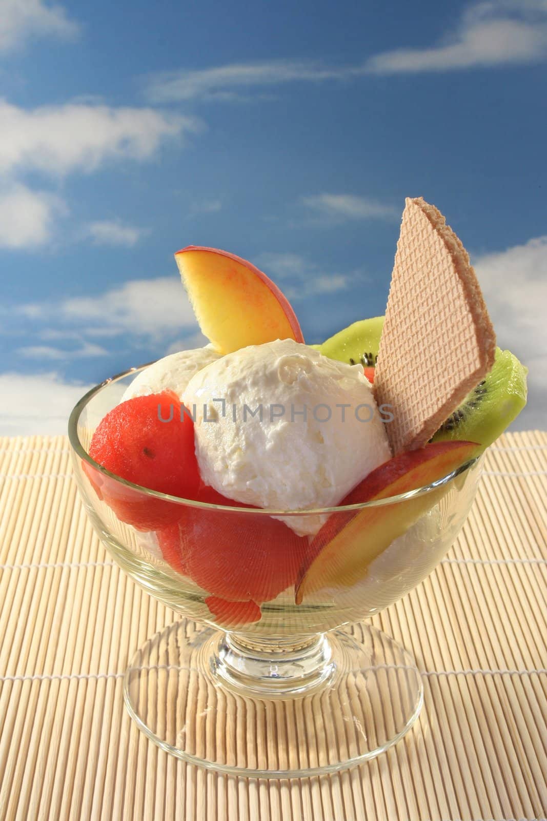 Fruit sundae with fresh melon, kiwi and peach