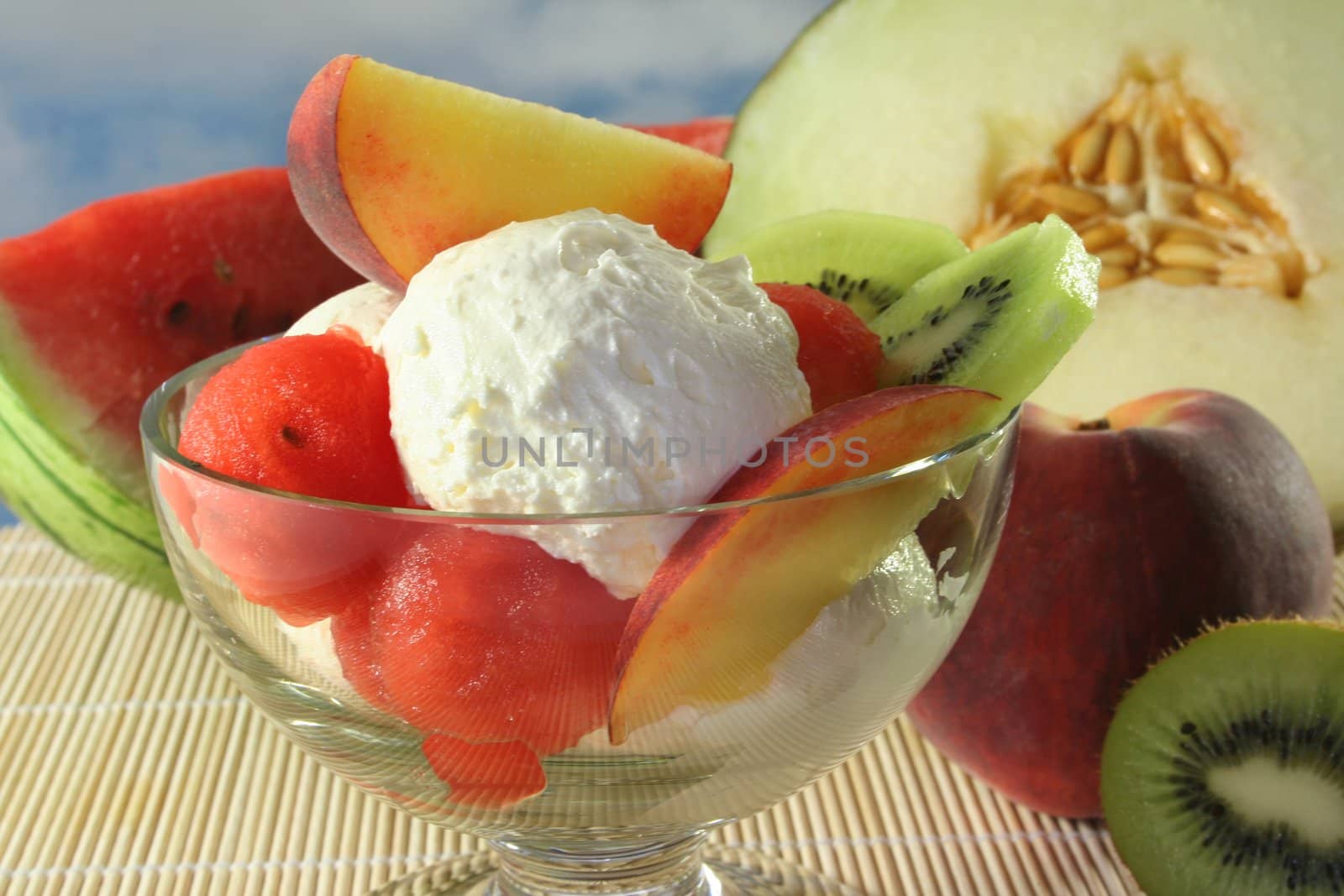 Fruit sundae with fresh melon, kiwi and peach