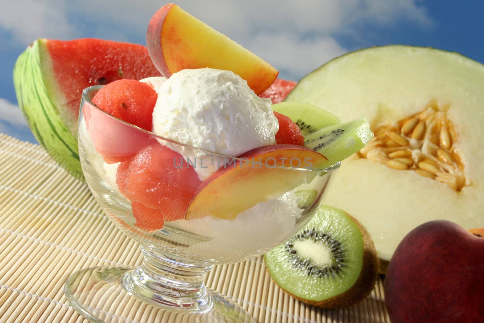Fruit sundae with fresh melon, kiwi and peach