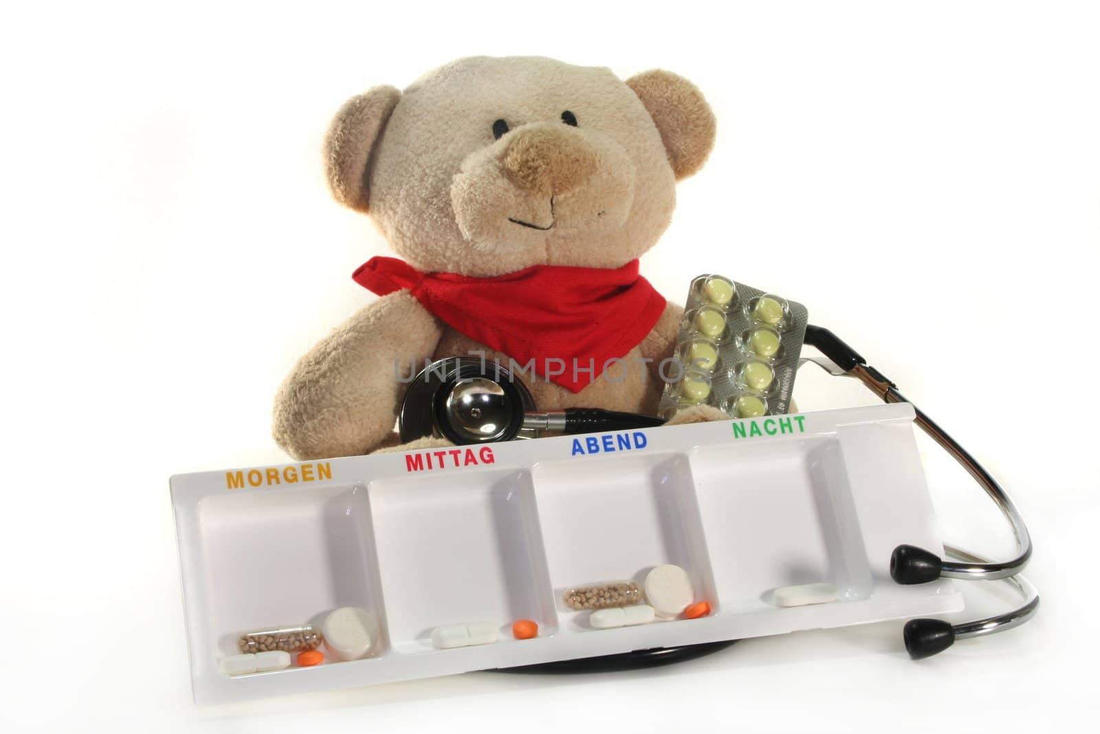 Teddy with a stethoscope and medication before a white background