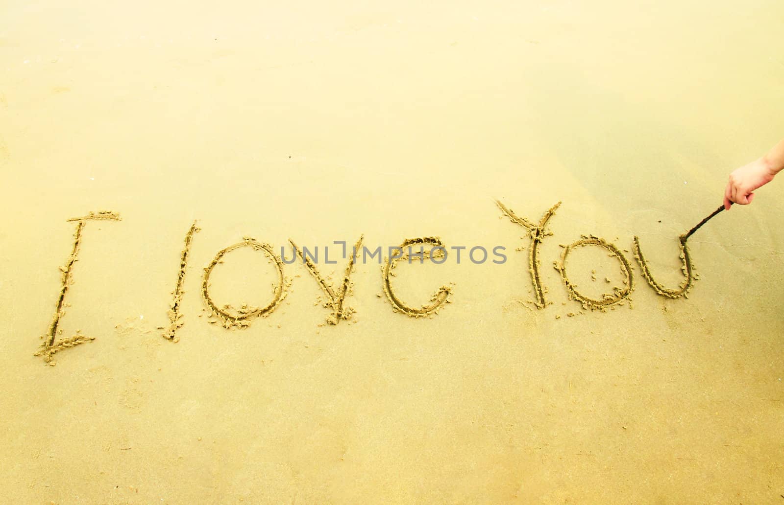 Hand writing I love you on sand by nuchylee