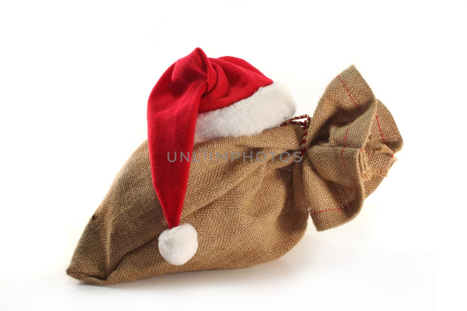 a sack with Santa Claus hat on white background