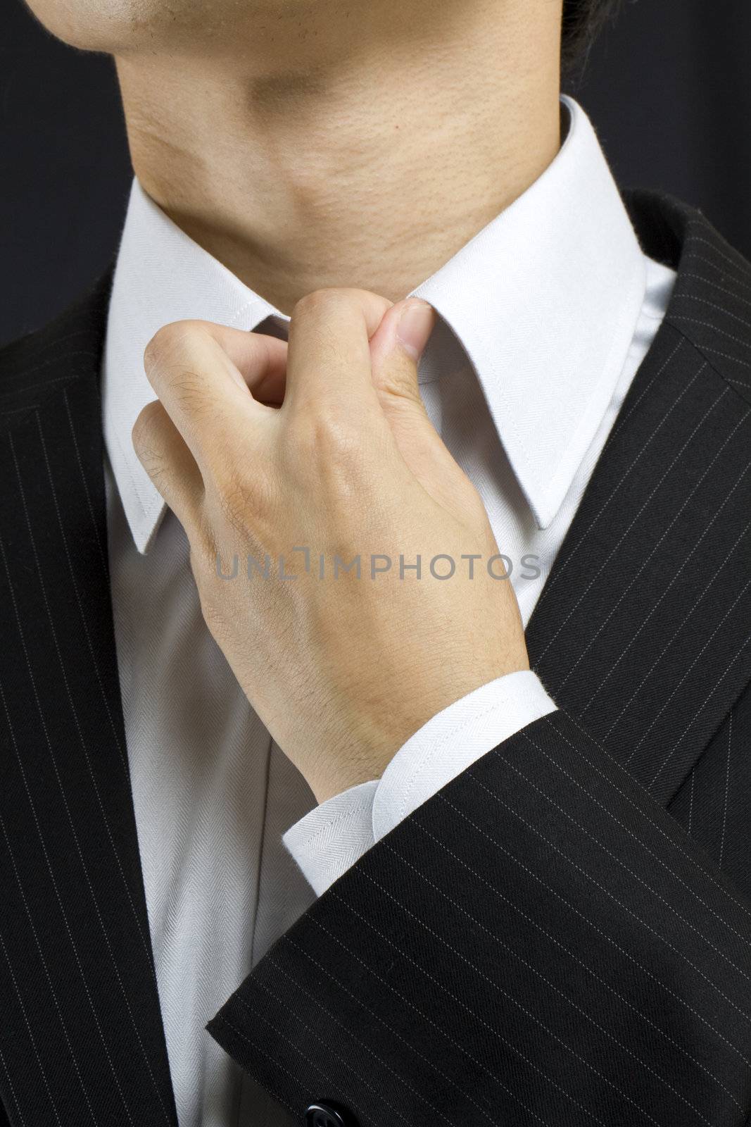 Business man adjusting his suit
