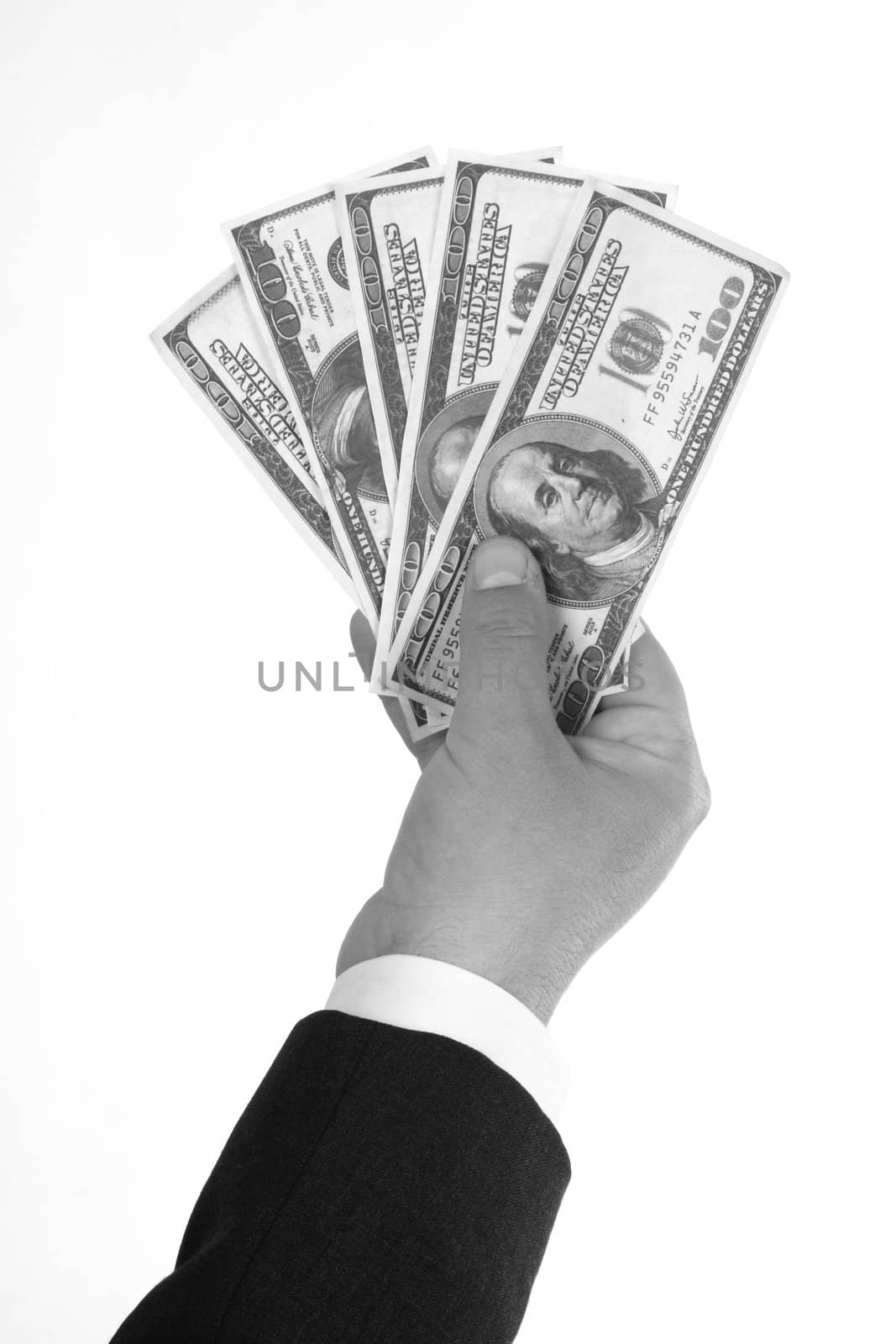 Man's hand holding dollar bills over white. Black and white picture