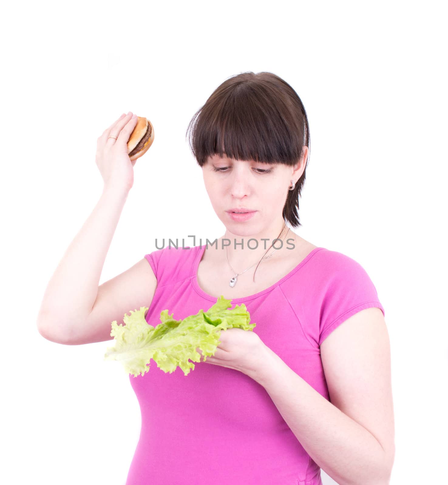 The young woman throws out a hamburger holding salad