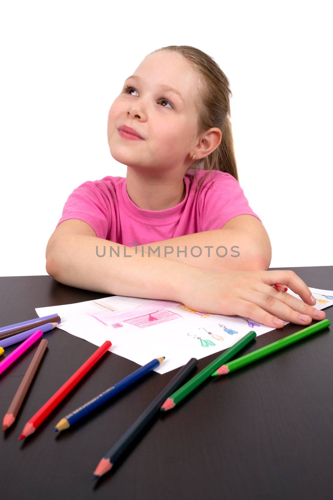 The girl draws a picture color pencils