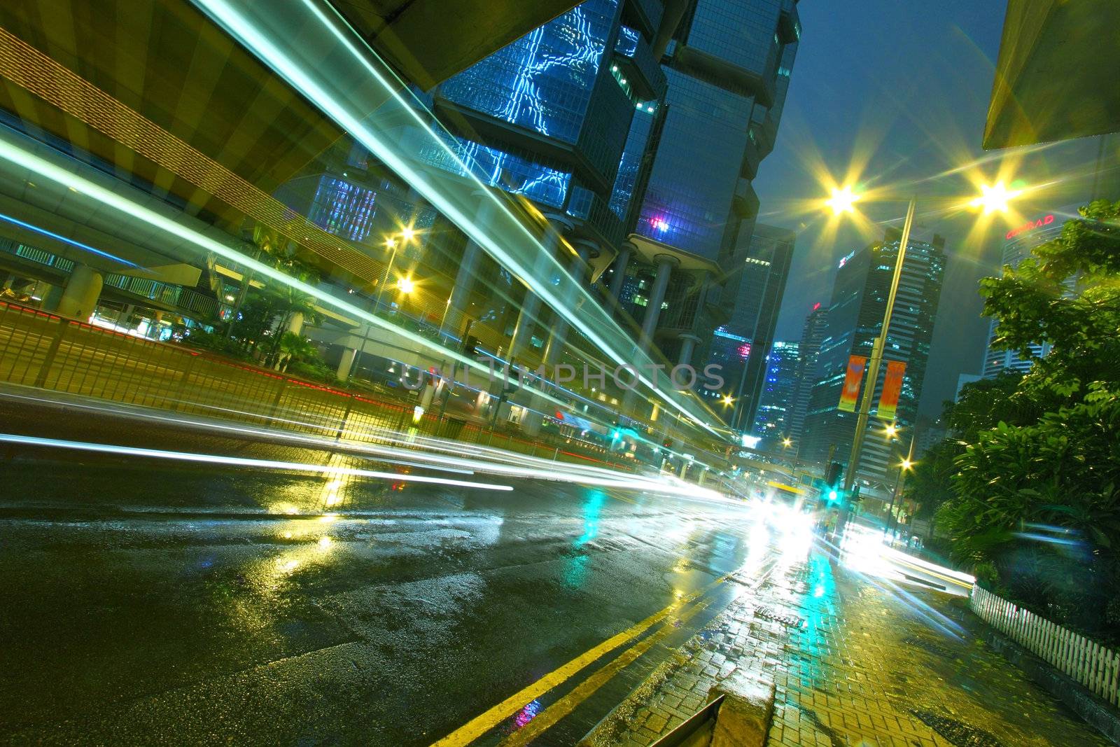 Traffic in city at night with office buiidings background