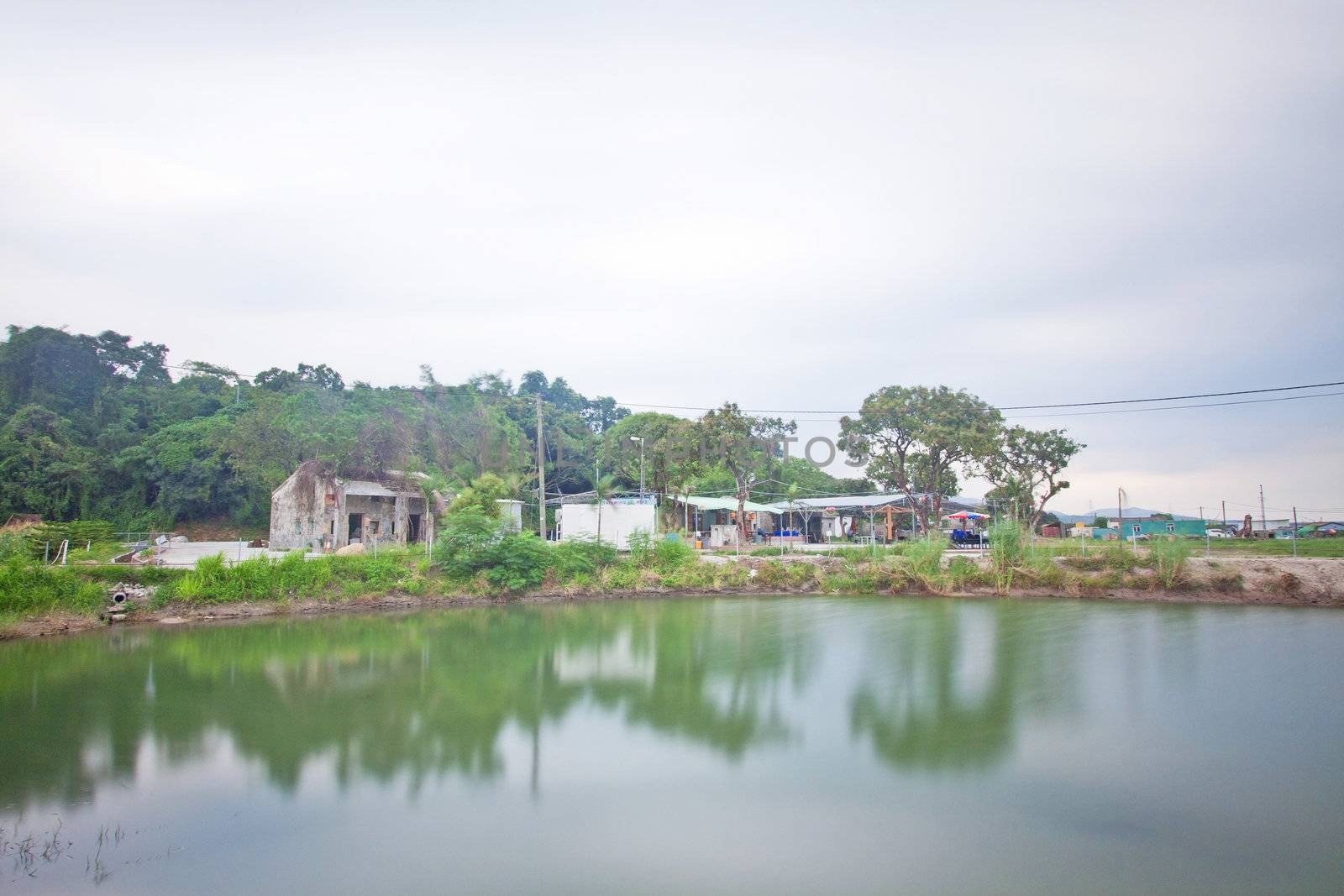 Chinese houses and garden with a pond outside by kawing921