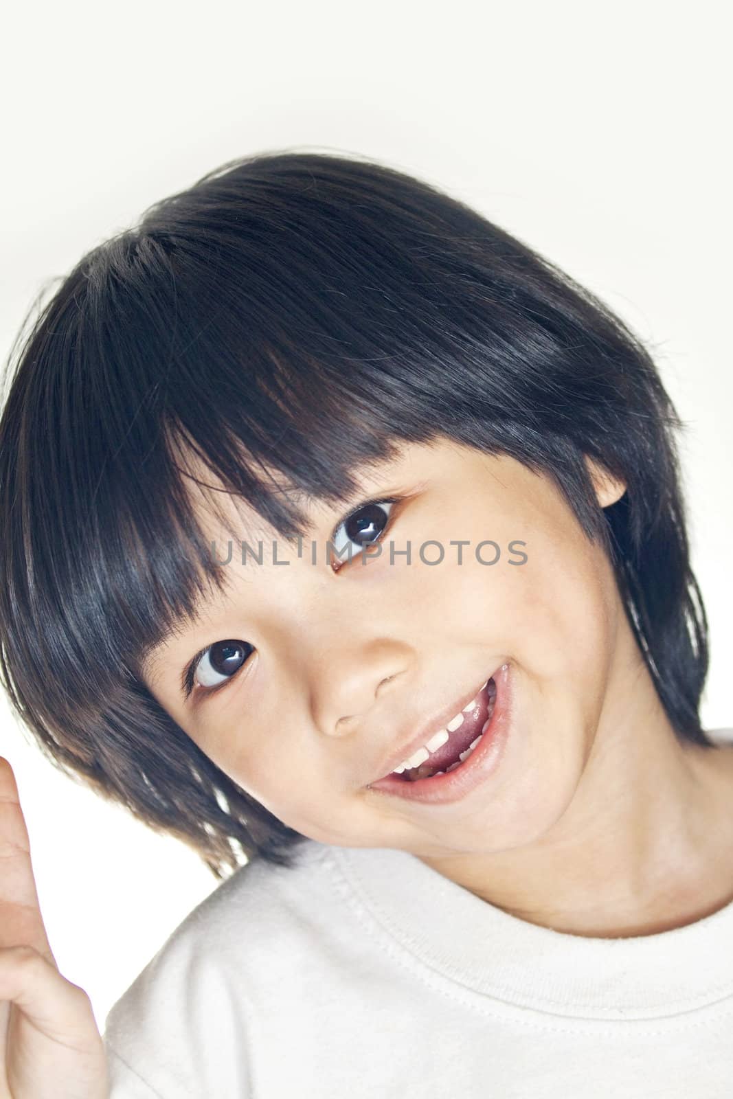 A young asian girl smiling, studio shot. by kawing921