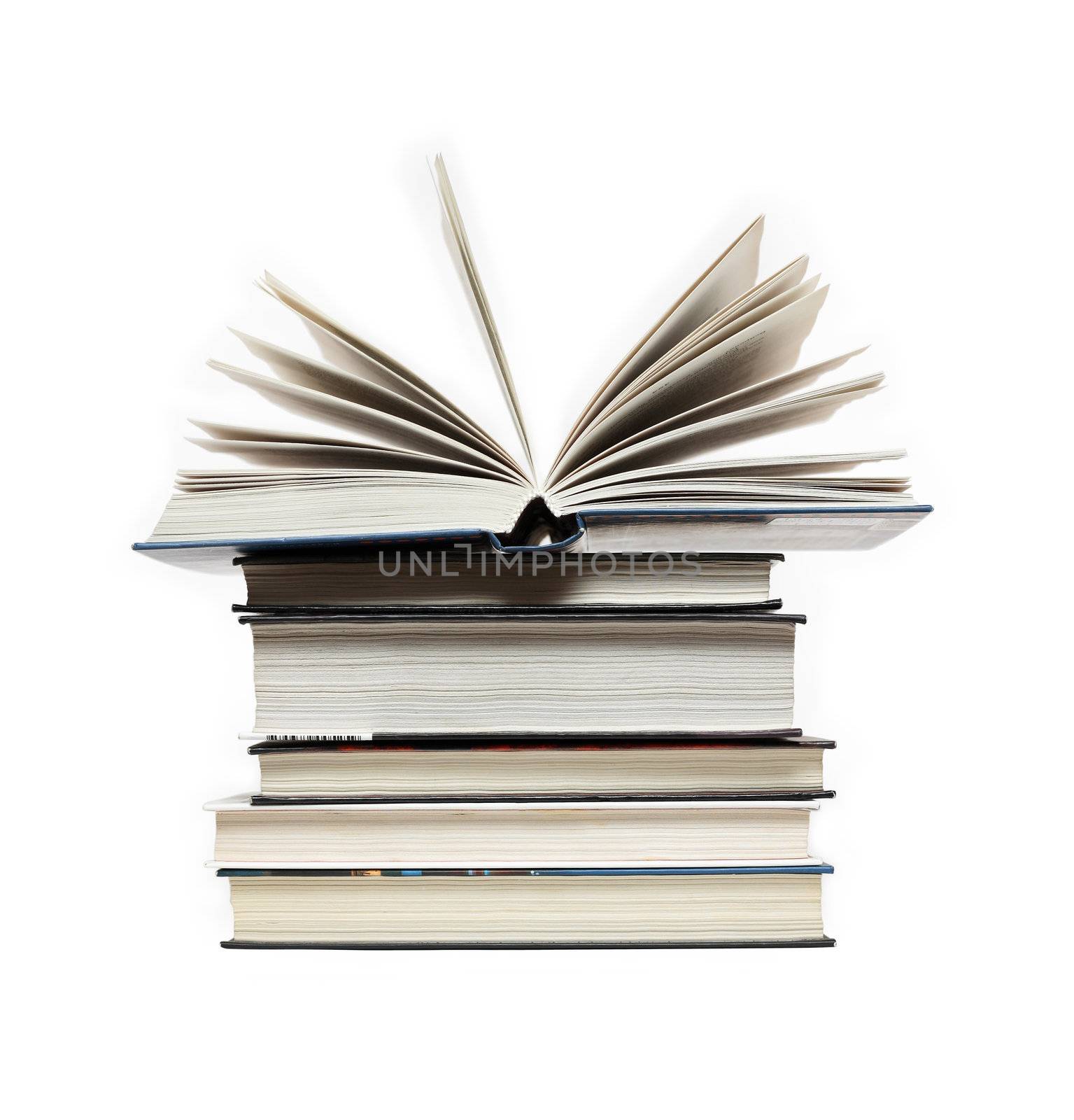 Open book lying on high stack of books on white background