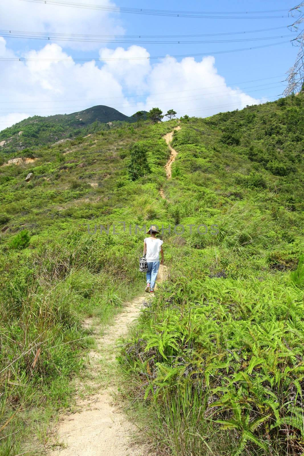 Woman hiking in mountains by kawing921