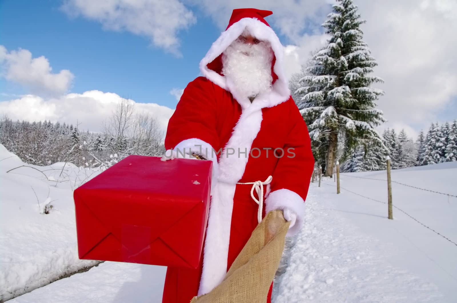 Santa Claus, Father Christmas holds red present