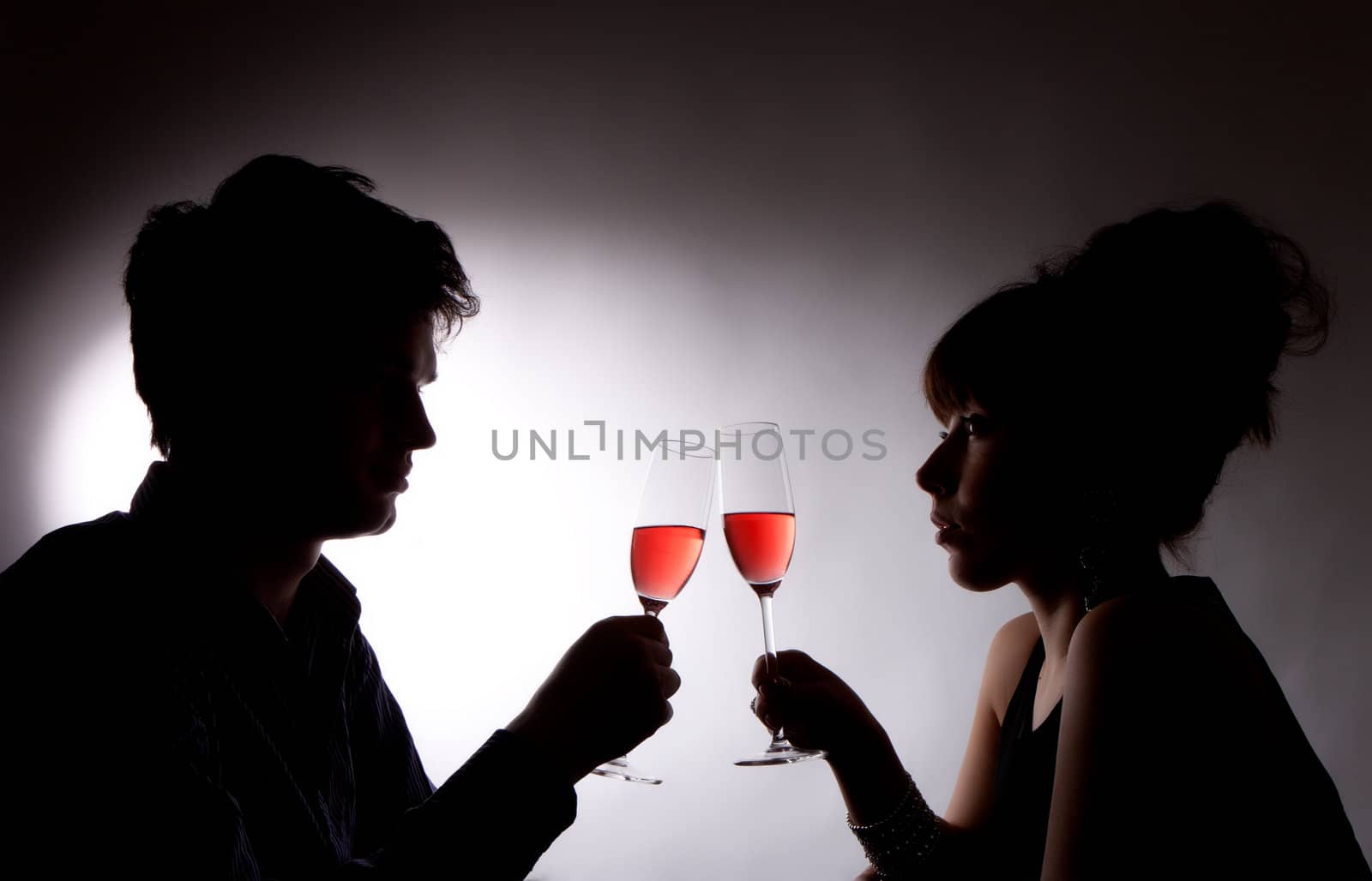 A young couple drinking rose wine by Discovod