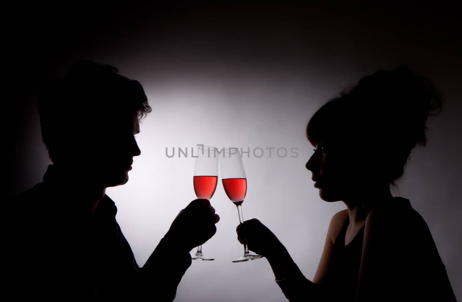 A young couple drinking rose wine by Discovod