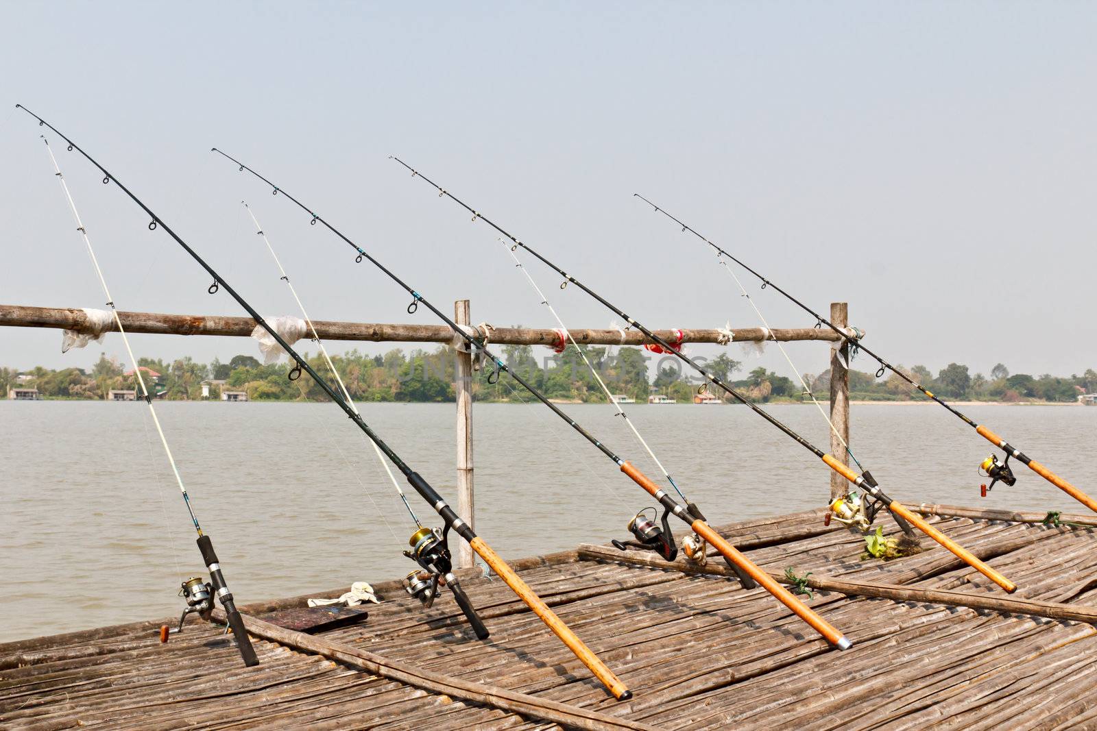 Fishing Poles on Pier  by stoonn