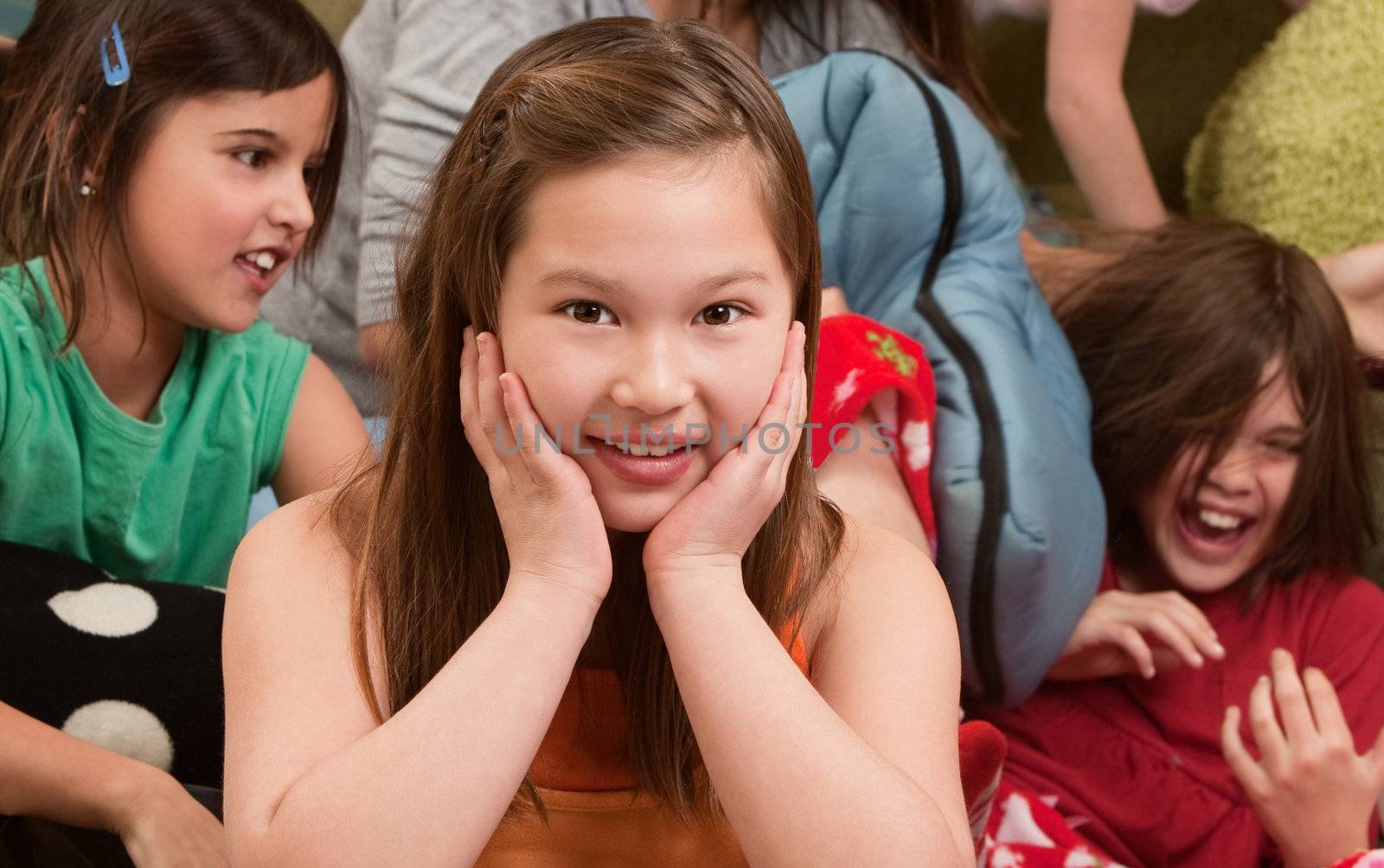 Smiling little girl at a sleepover with her friends 