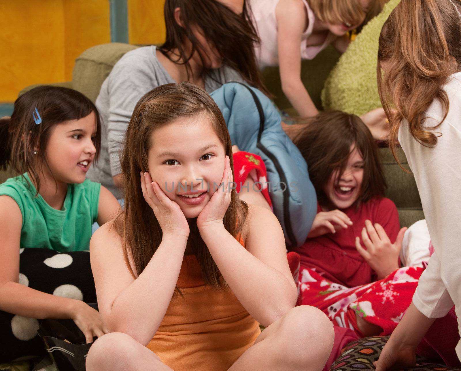 Smiling little girl at a sleepover with her friends 