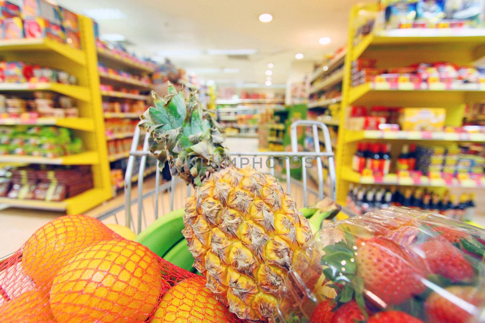 Moving shopping cart in supermarket. It was taken with a slow shutter from the shopper's point of view.