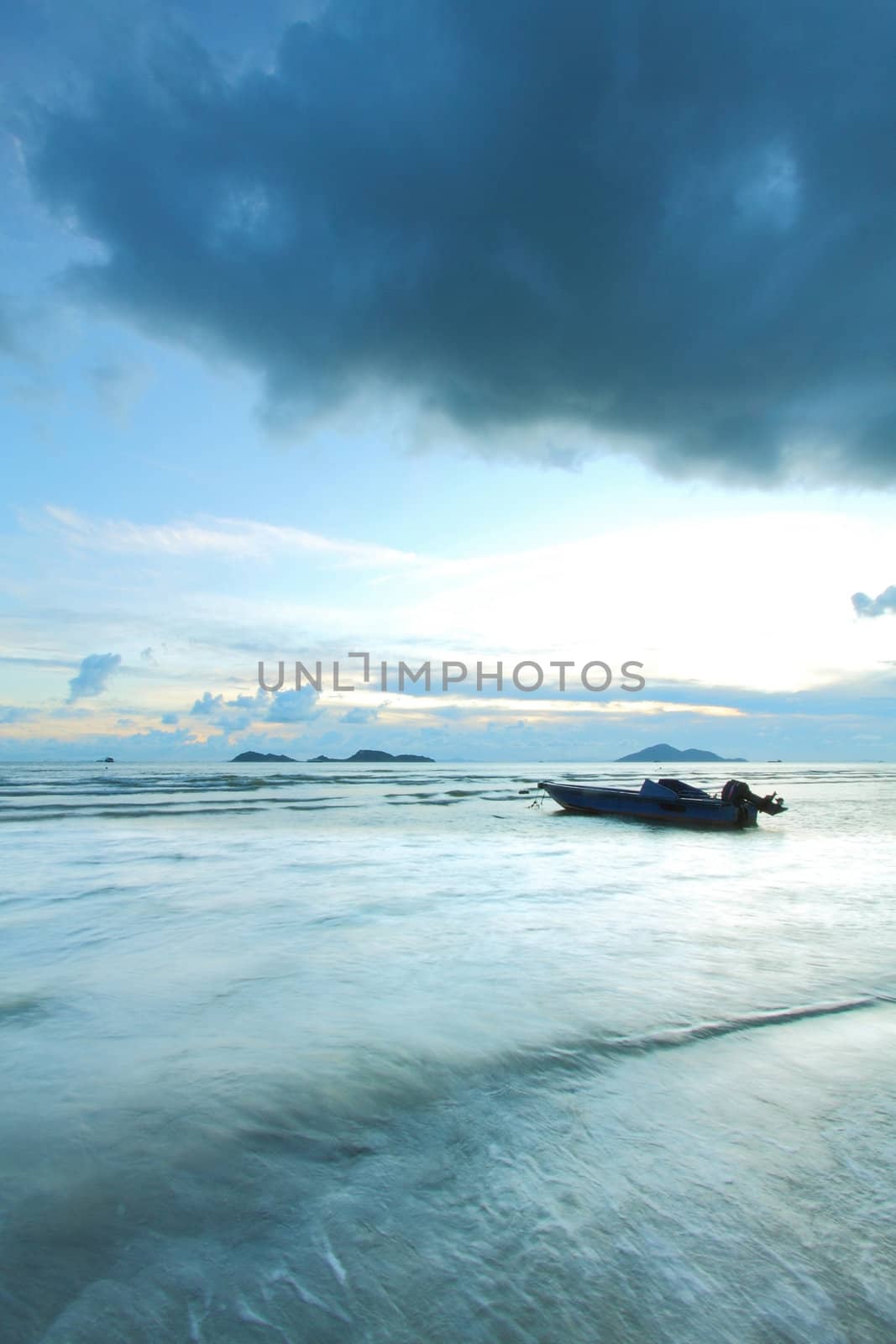 A boat in the sea with thunderstorm coming by kawing921