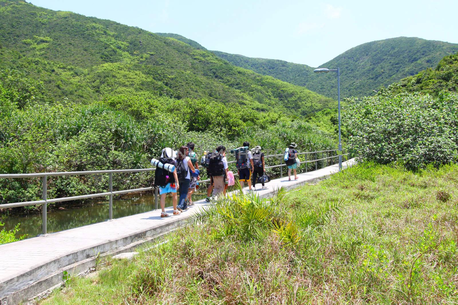 Asian hiking team in mountains of Hong Kong