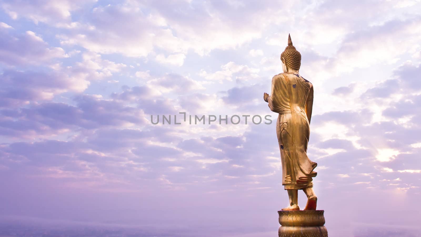 Walking Buddha statue by Suriyaphoto