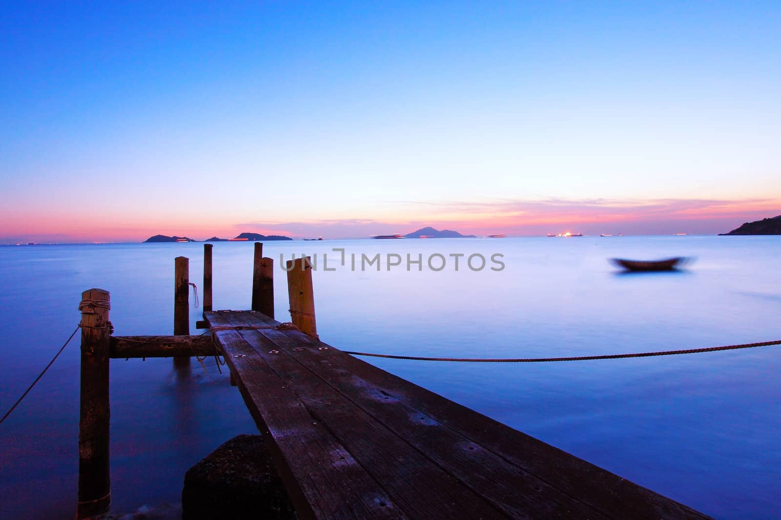 Sunset at dusk along a wooden pier