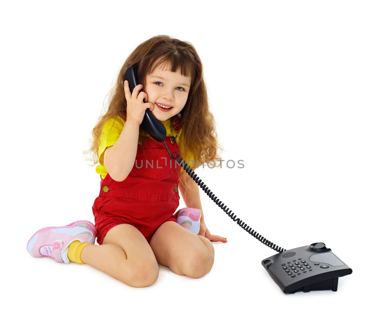 Little girl talking on the phone isolated on white background