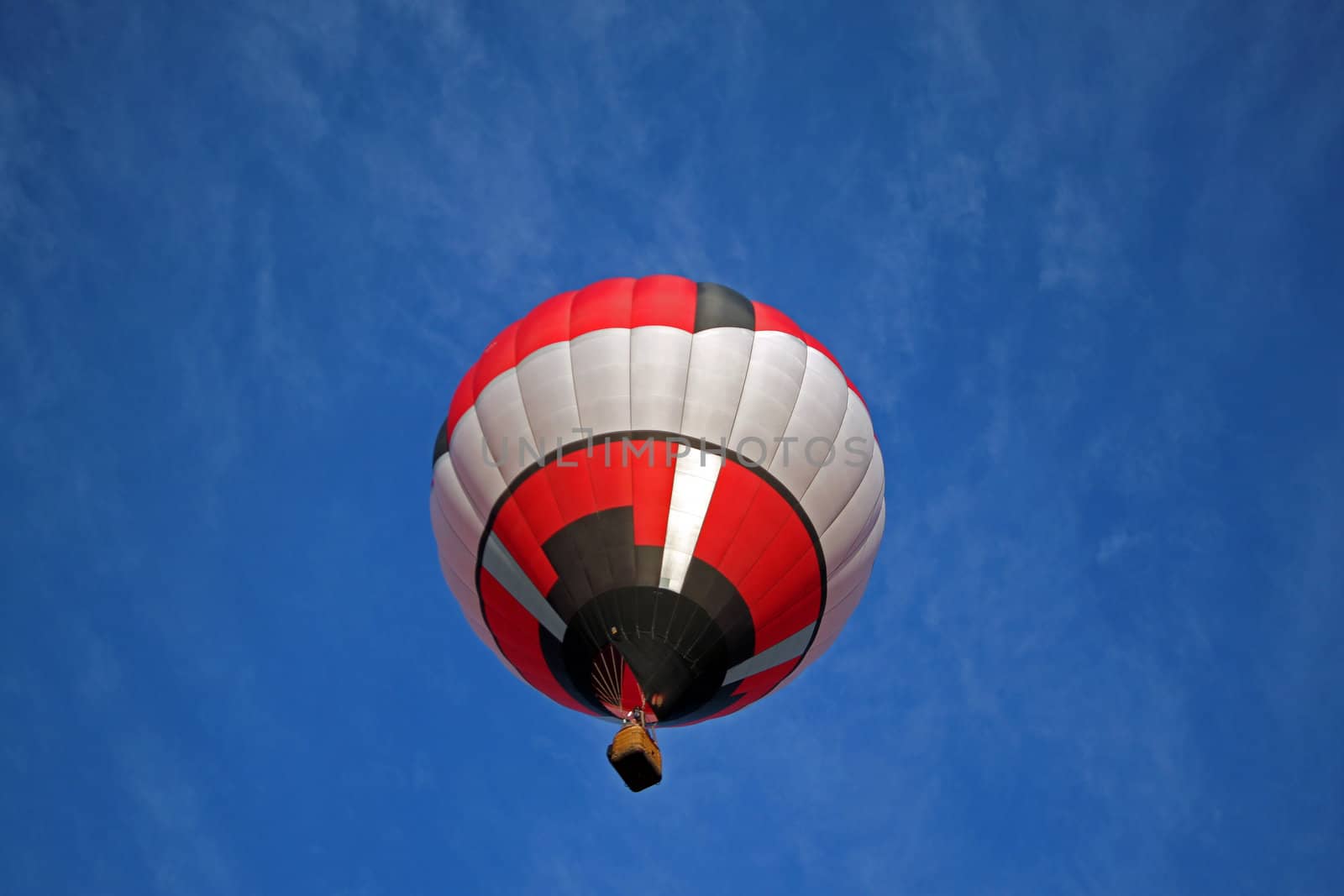 Hot air balloon on blue background with red black and white highlights.