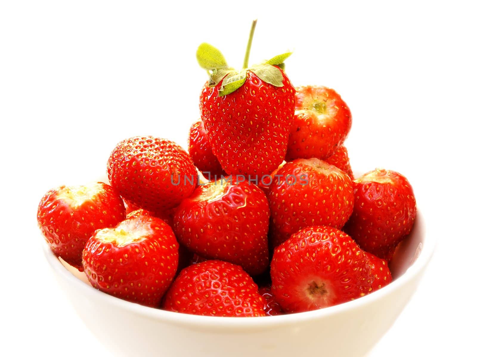Strawberry fruit in a white bowl, isolated towards white