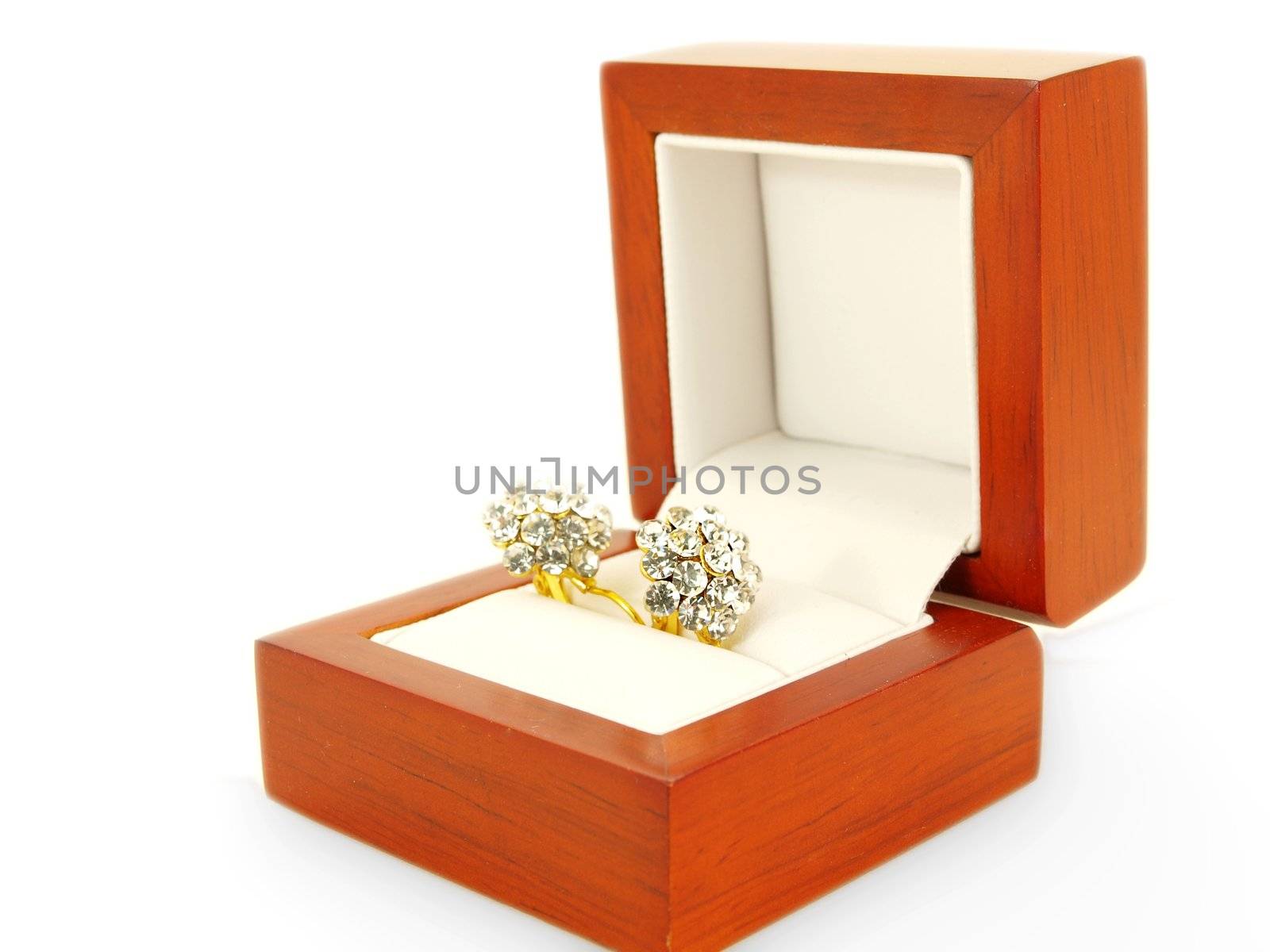 Diamond earrings and yellow gold, isolated towards white background, in a wooden gift box towards white background