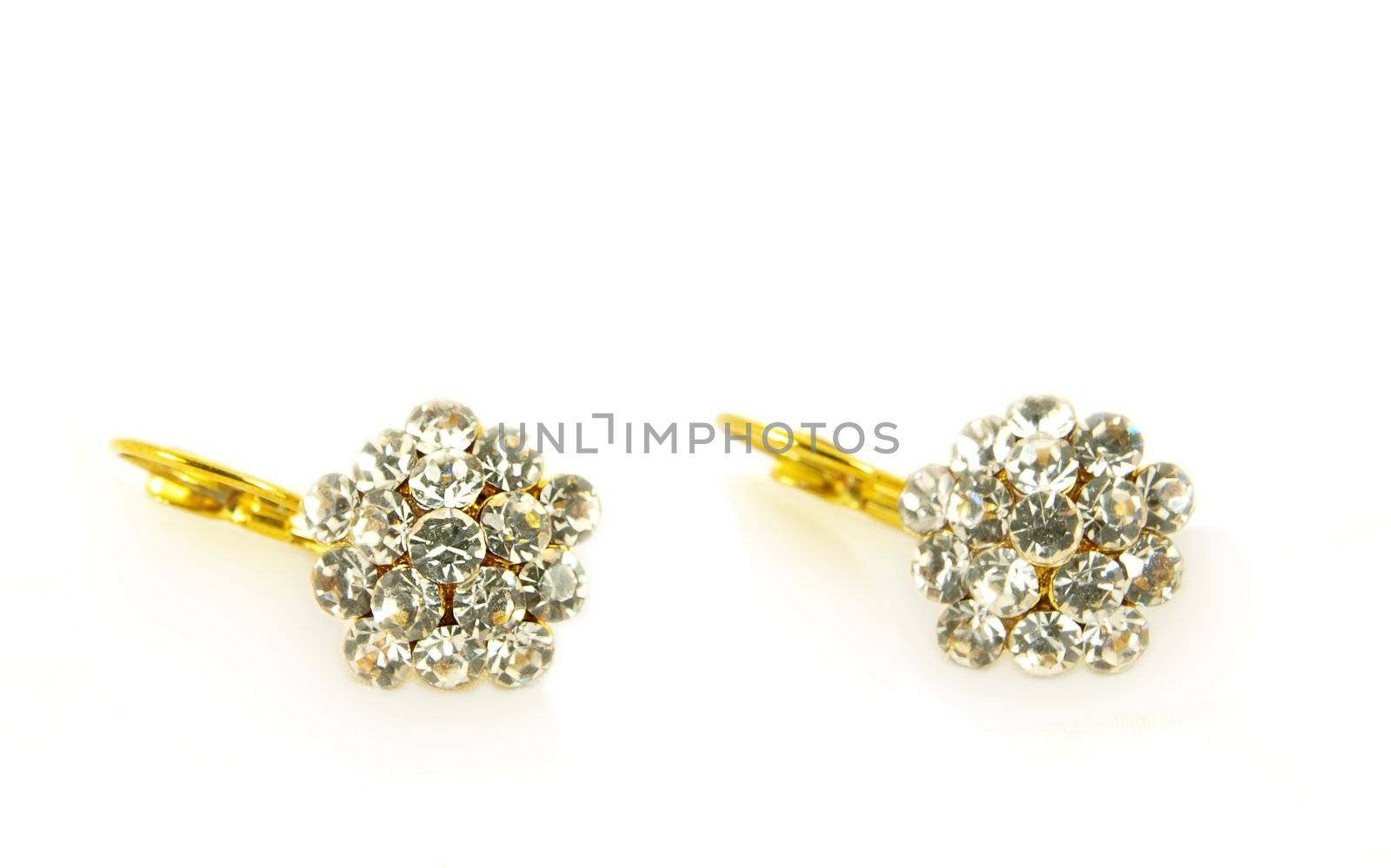 Diamond earrings on yellow gold, isolated towards white background