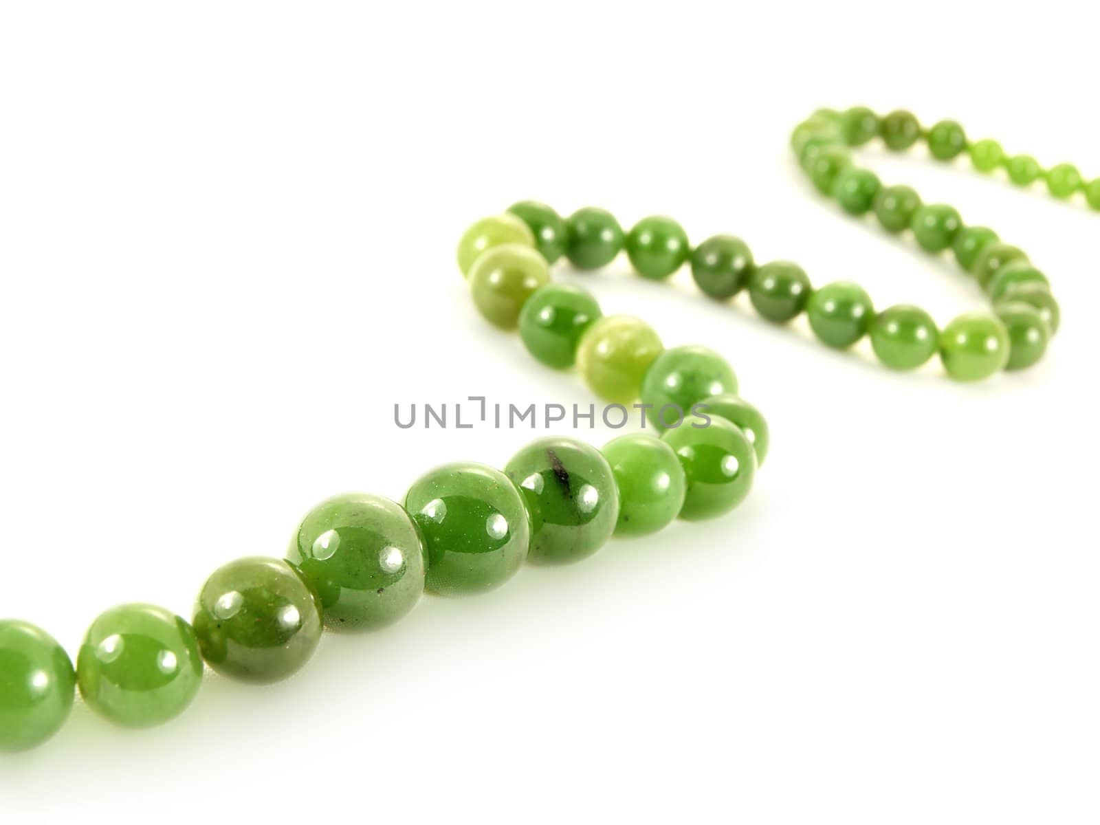 Green gemstone necklace, isolated towards white background