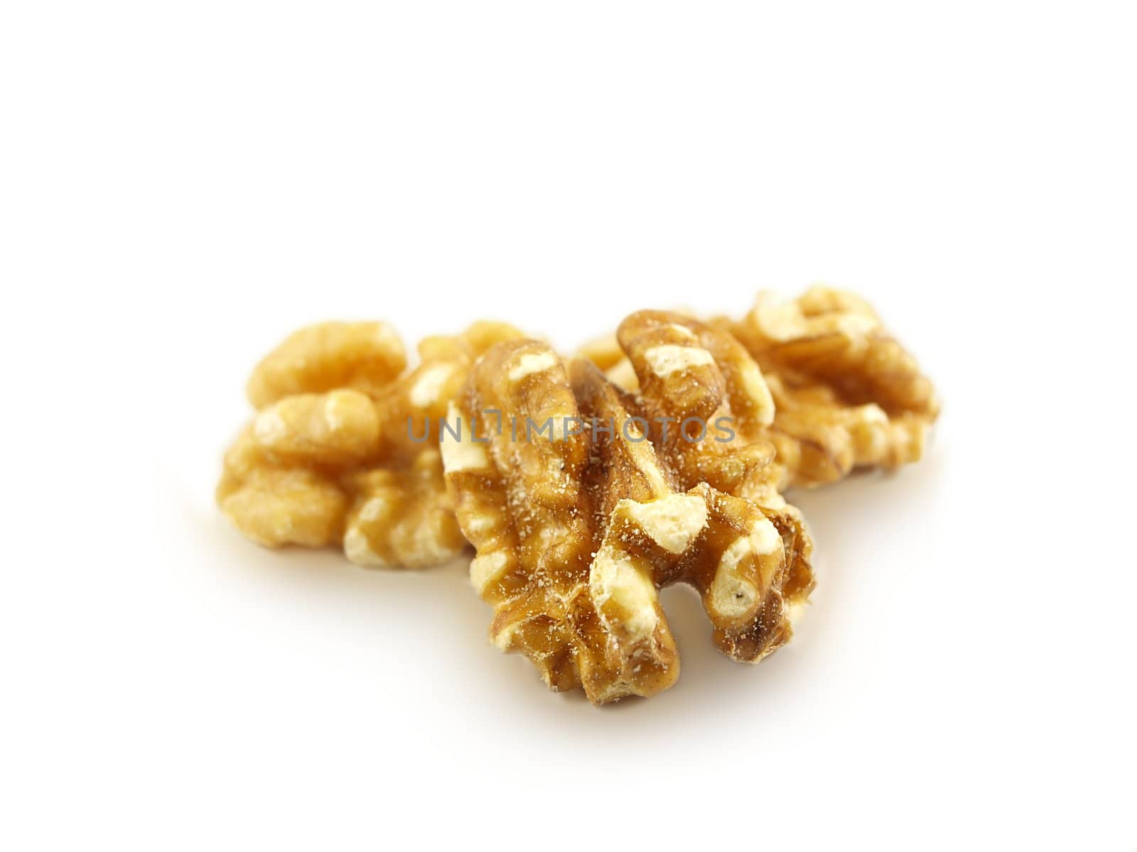 Walnuts in a pile isolated towards white background