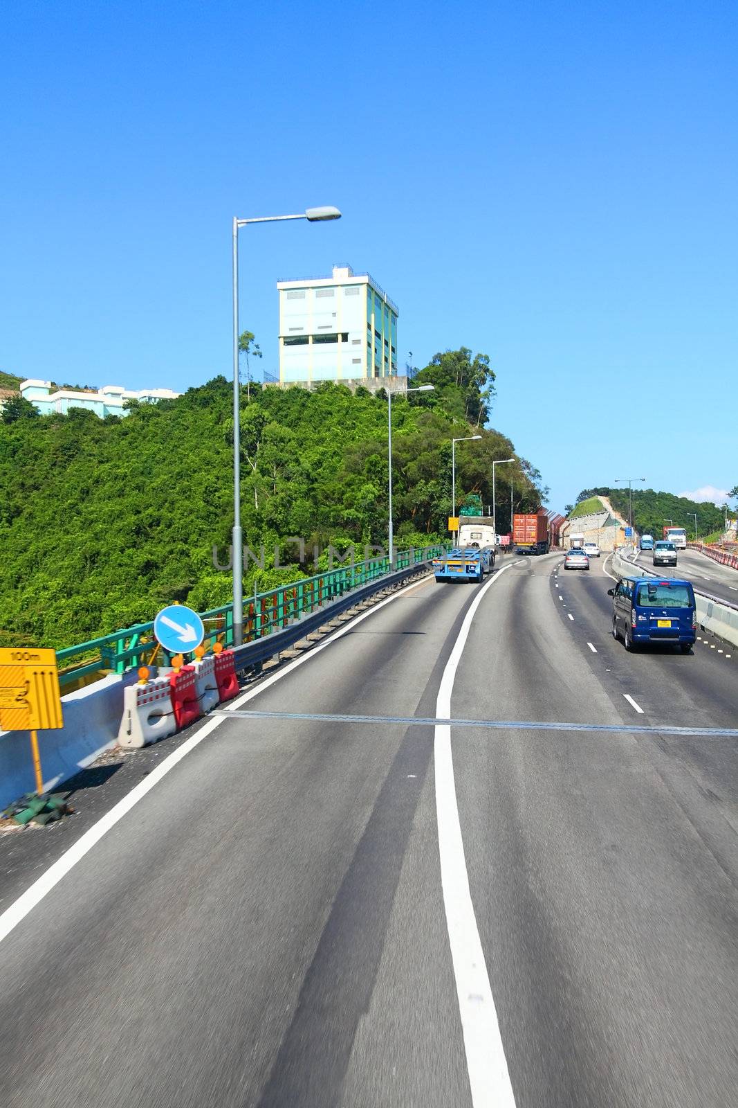 Highway in Hong Kong at day with moving cars