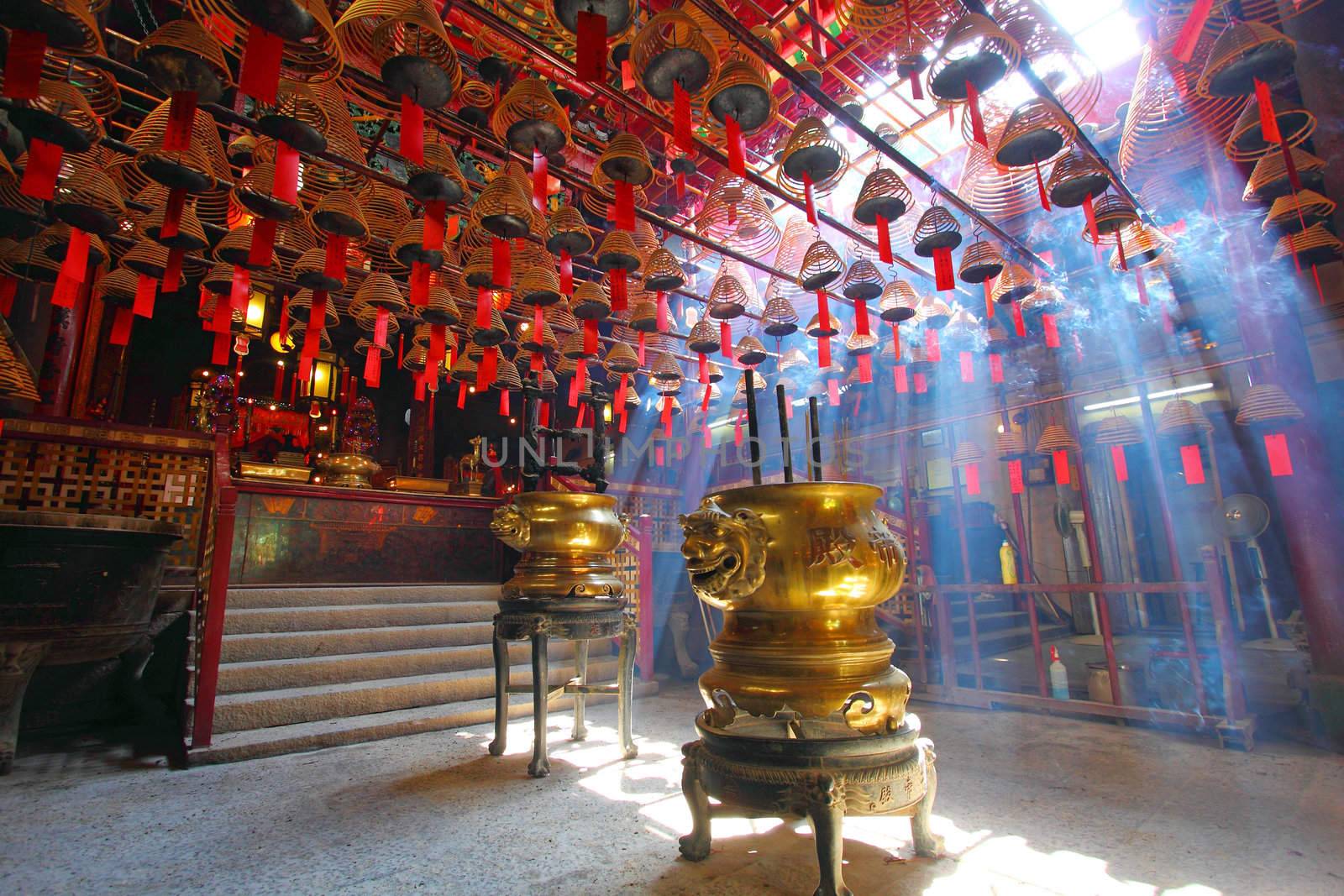 HONG KONG - JULY 26:Man Mo temple in Hong Kong with many incense coils on July 26, 2011. It was graded as a Grade I historic building in 1993 and it is now a declared monument. 